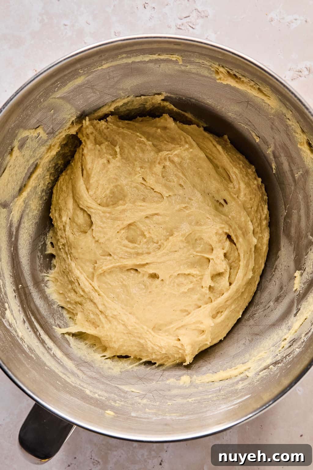cinnamon roll dough in a stand mixer after kneading.