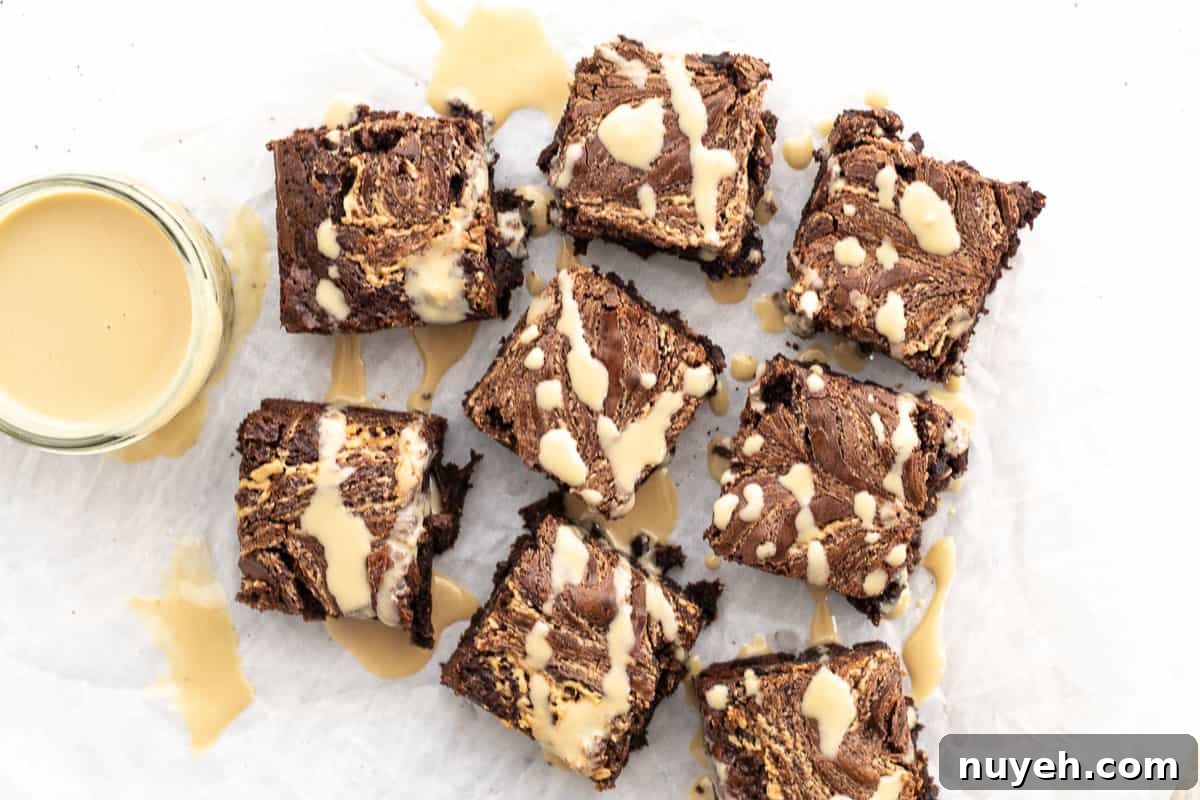 tahini brownies on parchment paper with tahini sauce