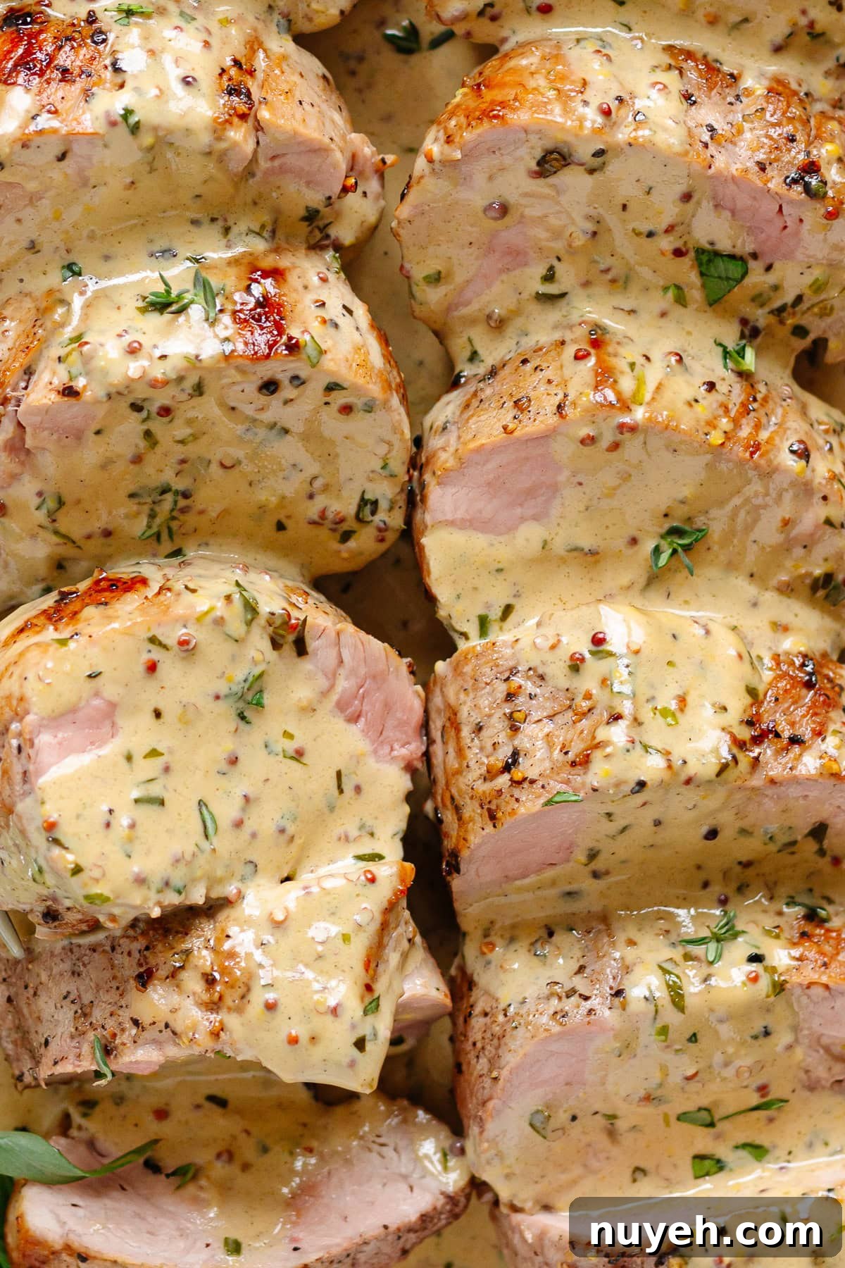 Sliced pork tenderloin covered in mustard cream sauce.