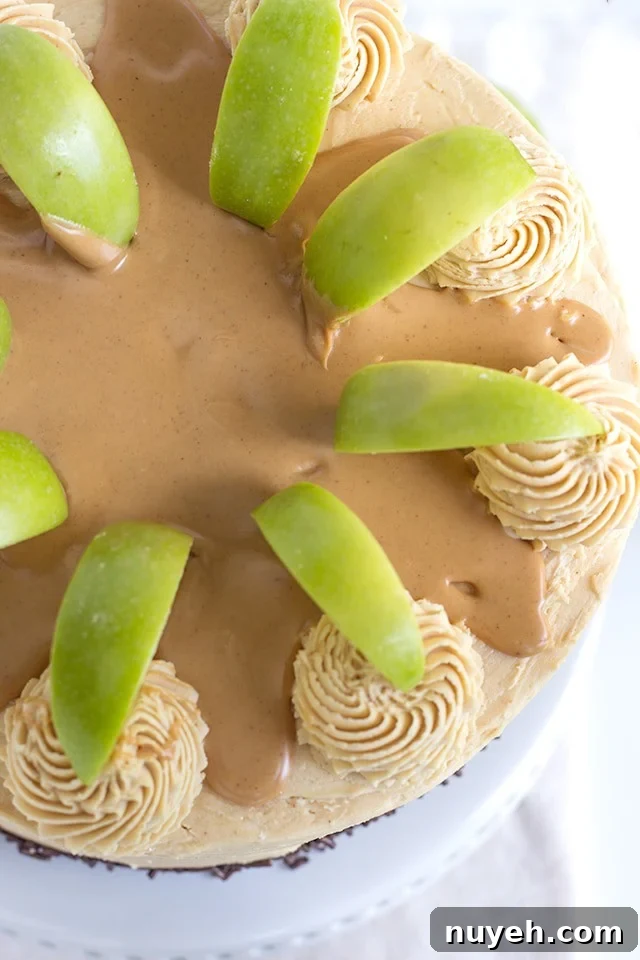 Top view, looking down on an Apple Cake with Peanut Butter Frosting garnished with green apple slices