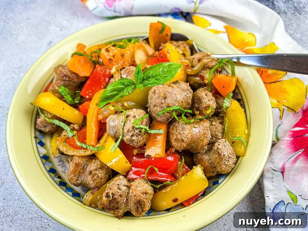 A bowl of sausage and peppers.