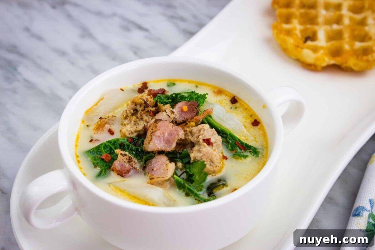 Low Carb Zuppa Toscana Soup in a white round bowl with small handles.