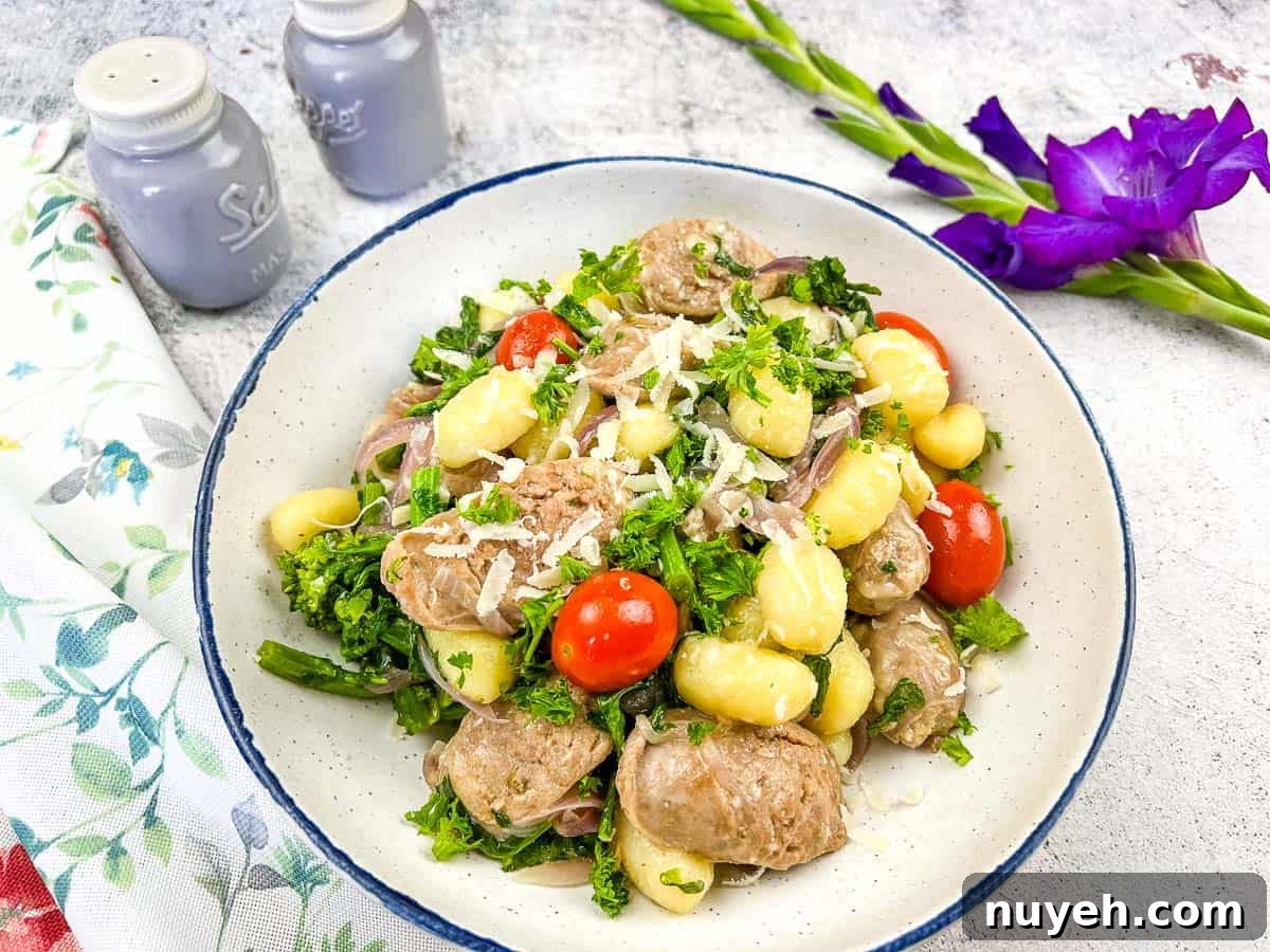A bowl of skillet gnocchi with sausage and broccoli rabe.