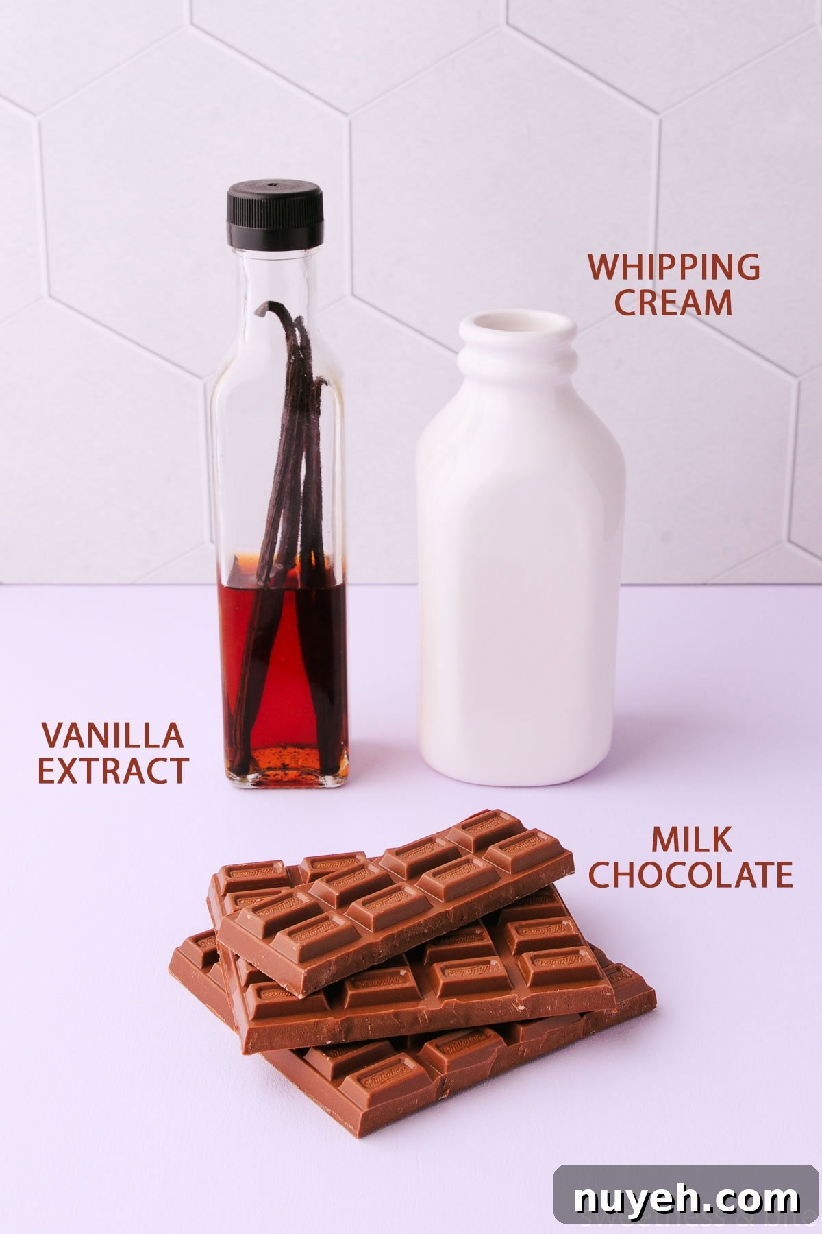 The labelled milk chocolate mousse ingredients - whipping cream, milk chocolate and vanilla extract.