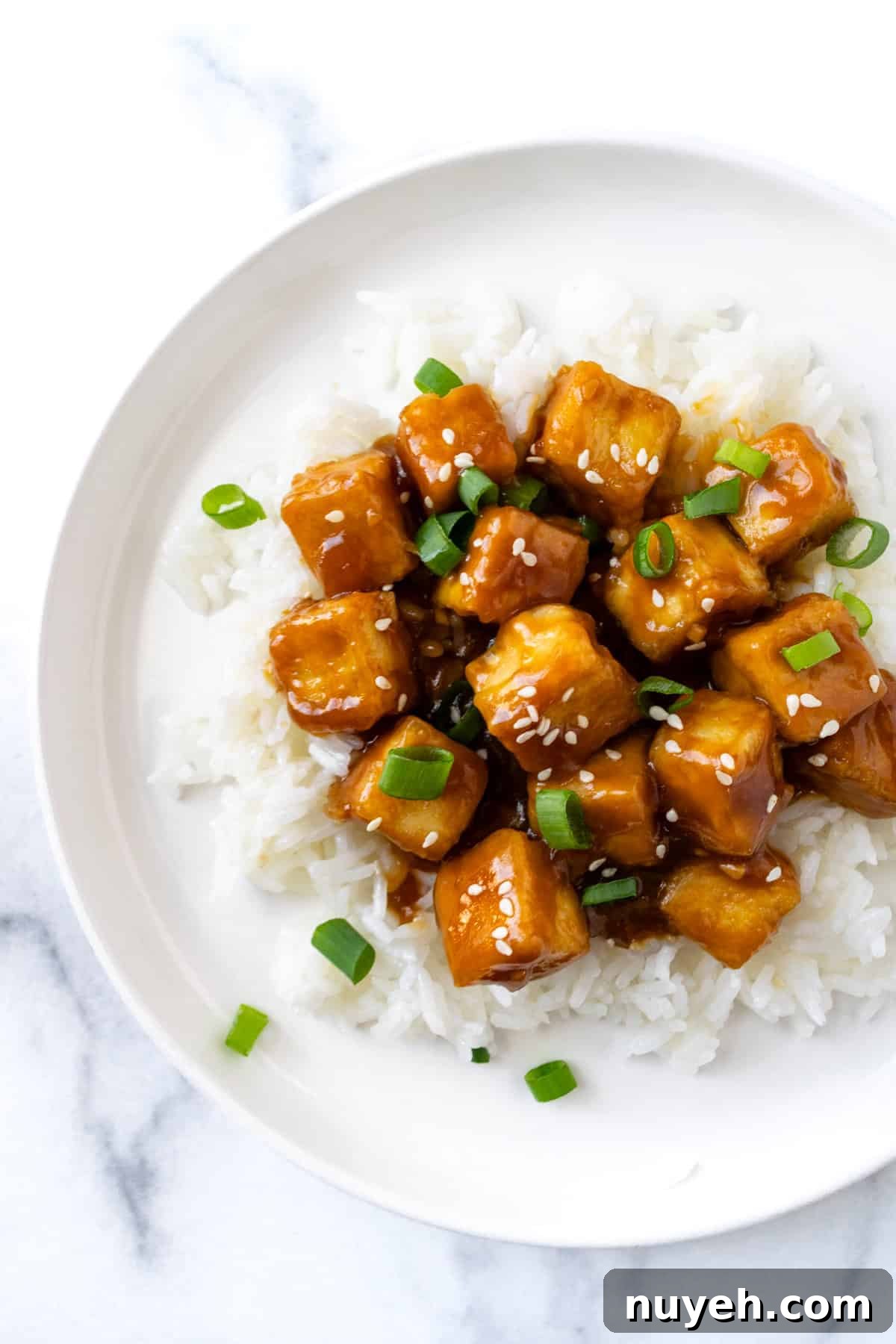 Crispy Orange Tofu Recipe with Sticky Citrus Glaze 8 Orange Tofu on white rice.