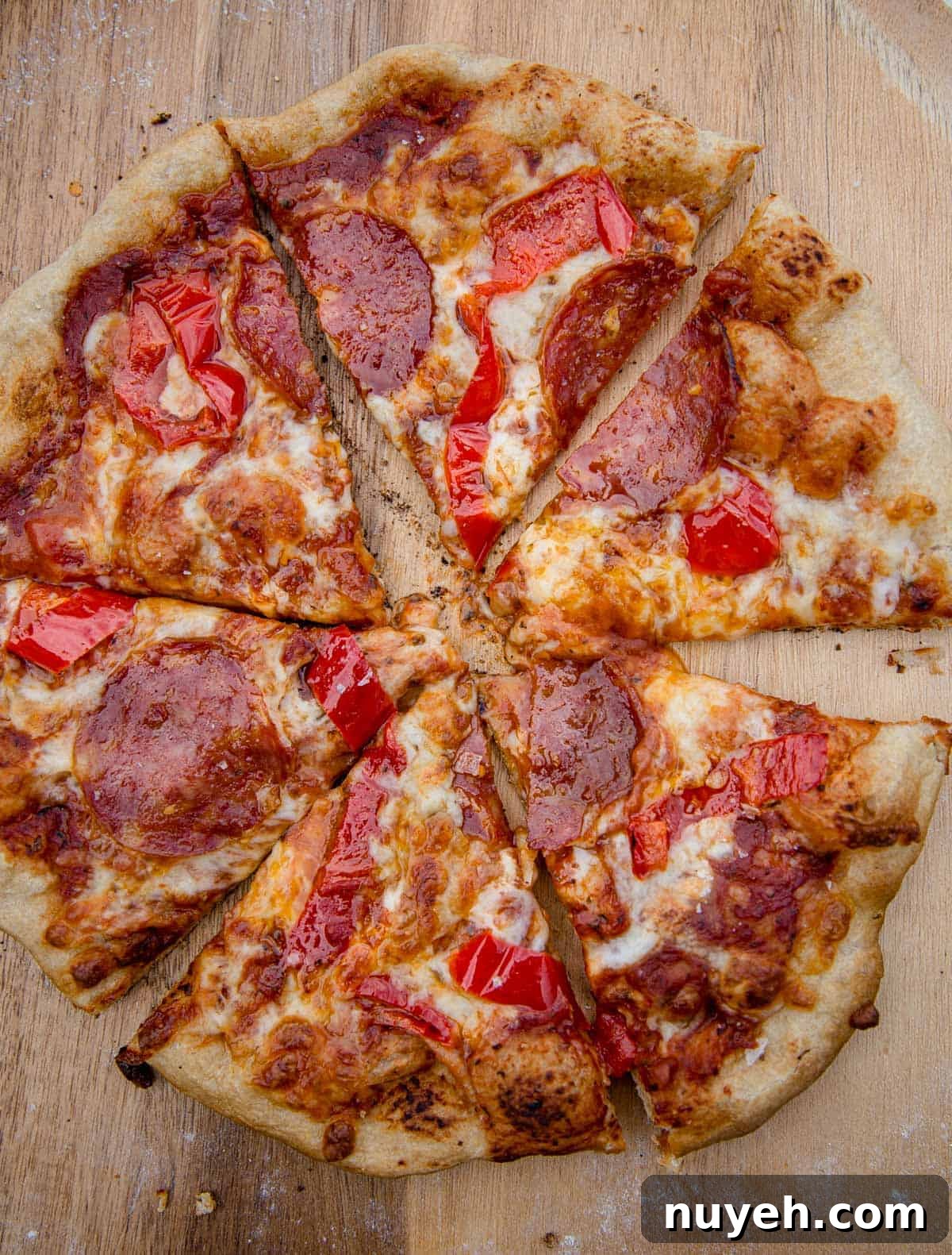A grilled pepperoni and hot pepper pizza, cut into 6 slices