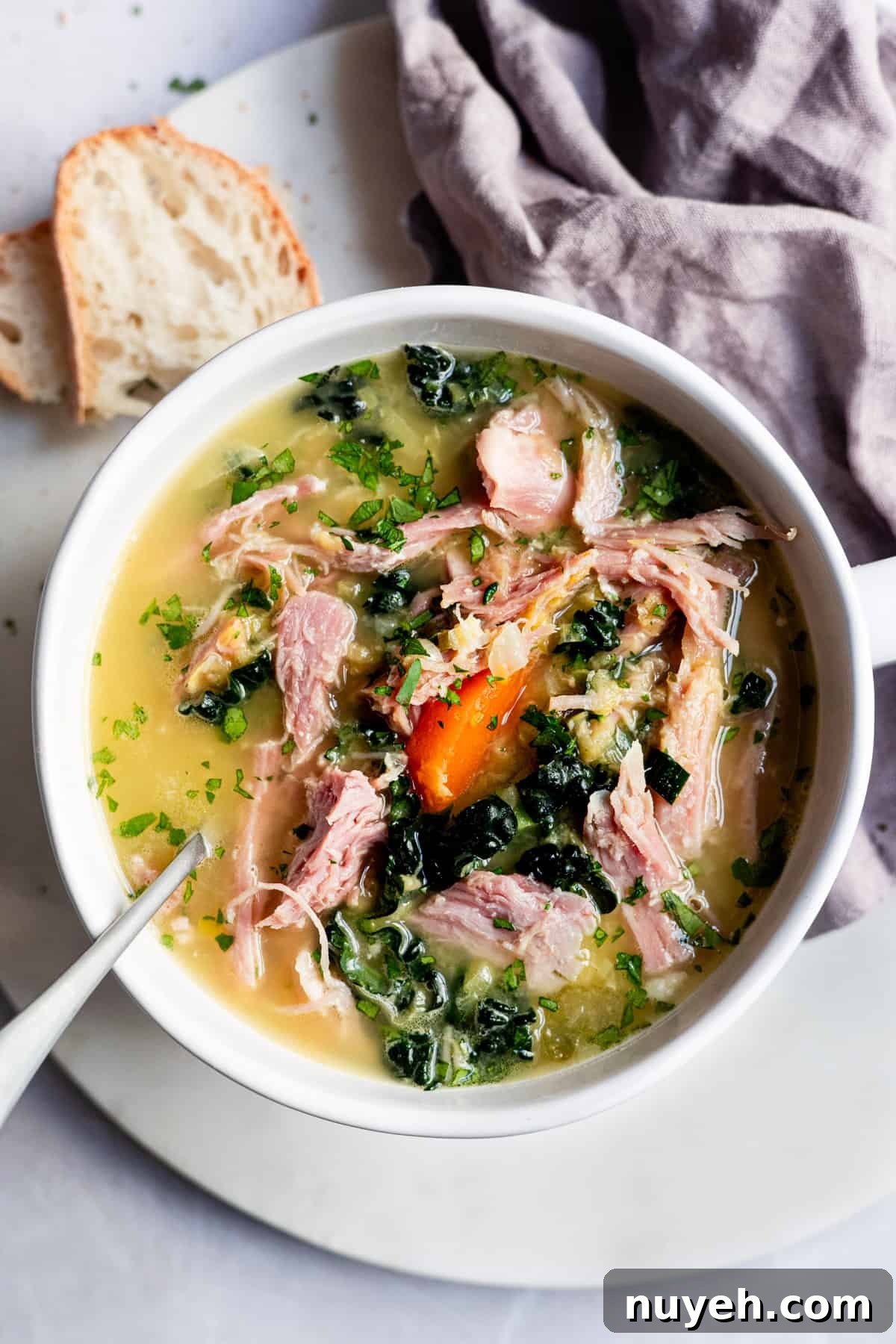 Slow Cooker Ham and Lentil Soup Recipe 2 ham and lentil soup in a white bowl.