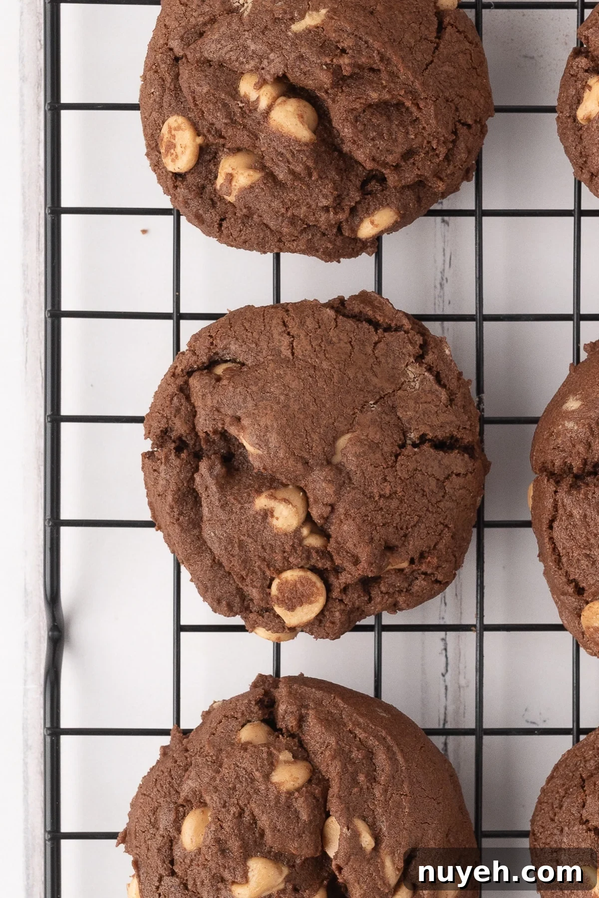 Chocolate and Reese's chip drop cookies freshly baked on a wire rack.