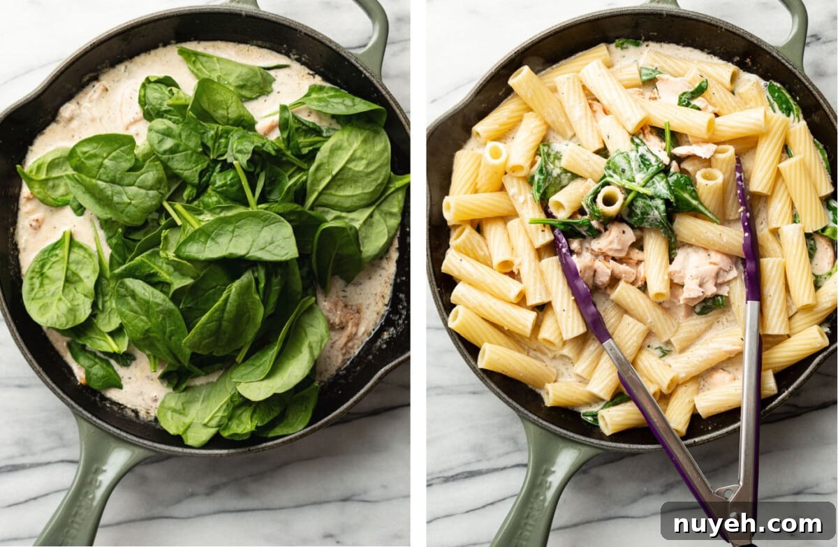adding spinach to a skillet and tossing with pasta and salmon