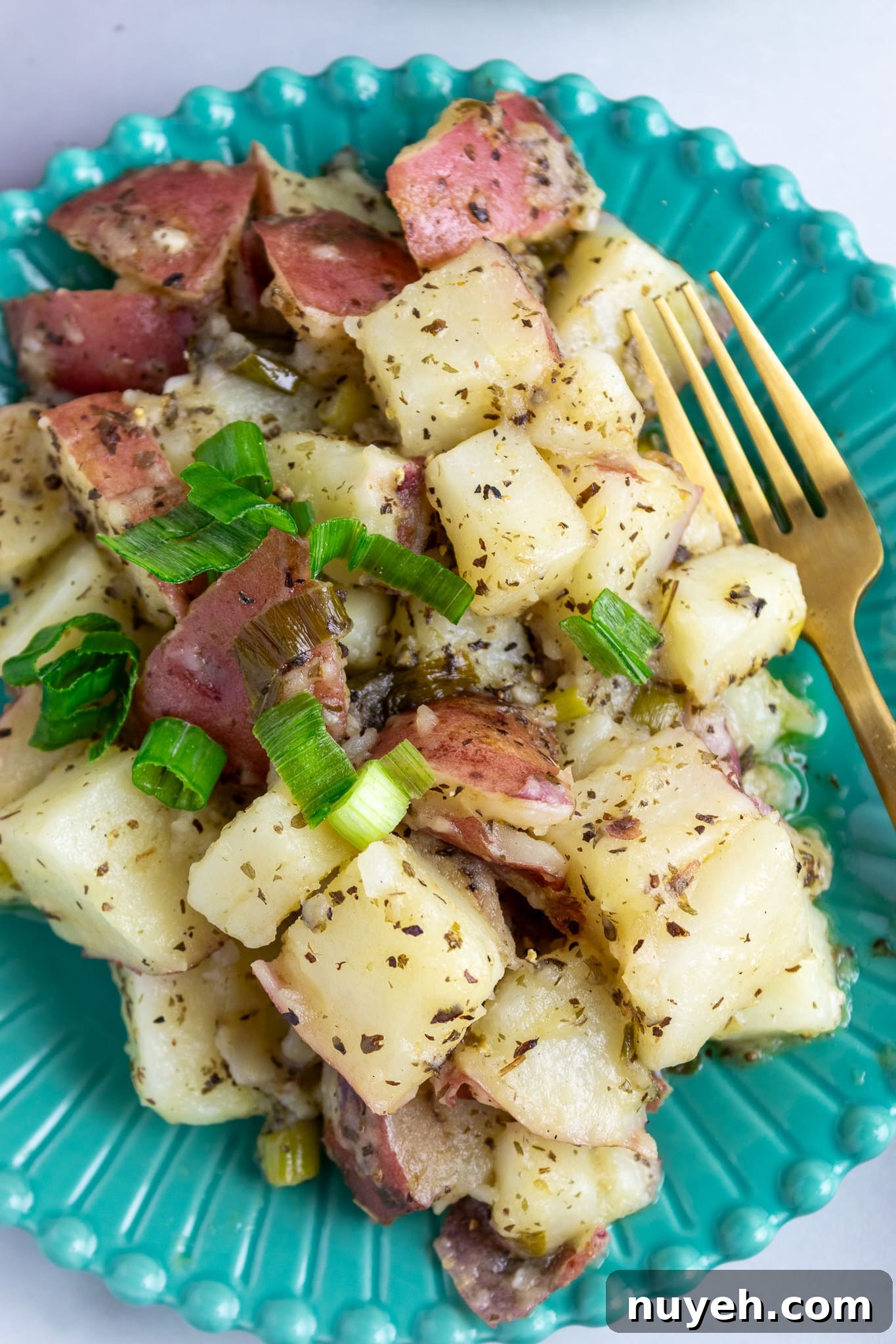 Grilled potato salad sizzling on a skillet