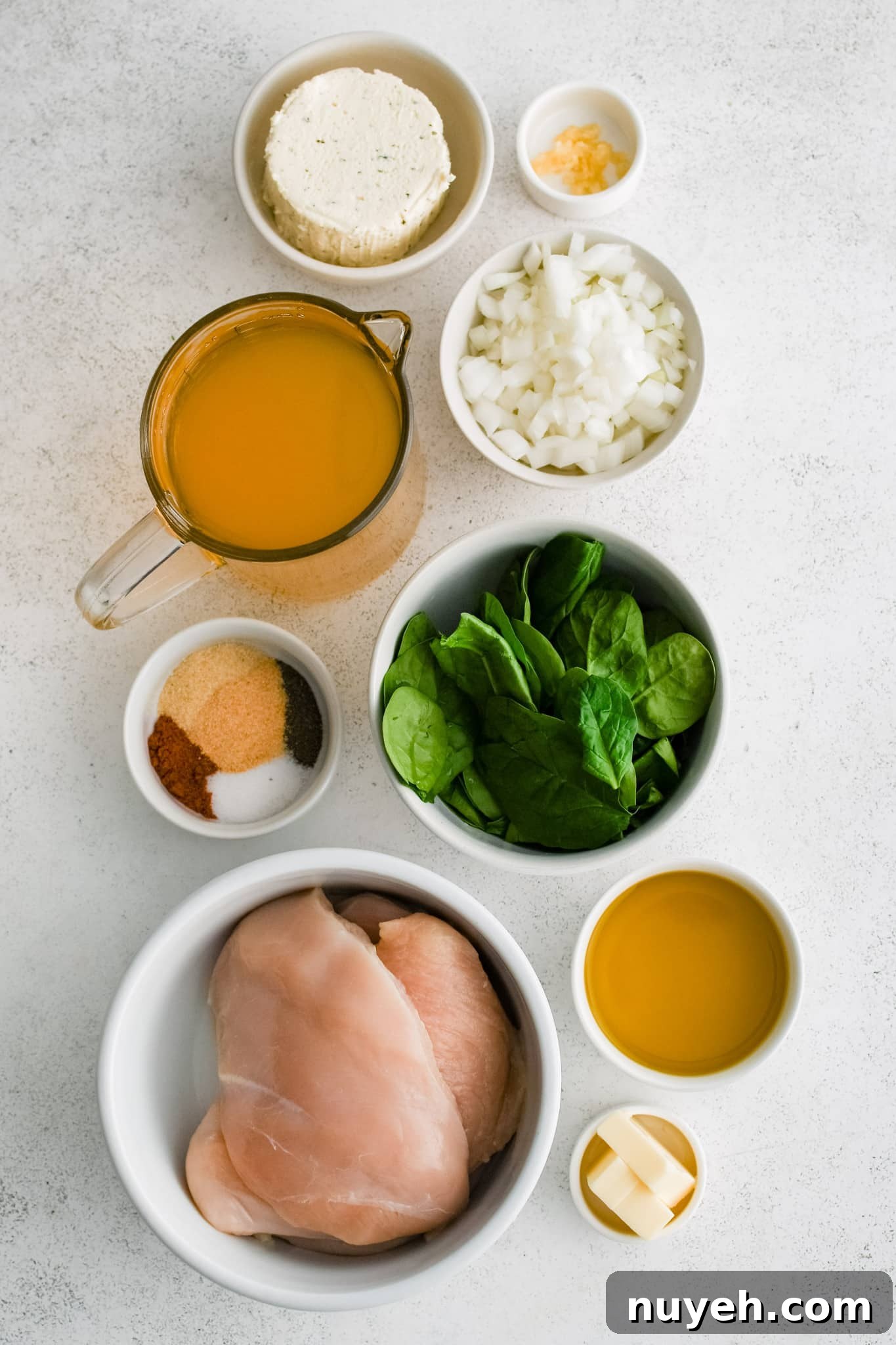 All of the ingredients needed to make creamy boursin chicken in individual measuring cups and ramekins.