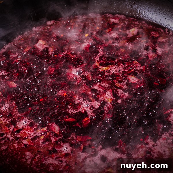 Red wine cherry sauce simmering in a skillet.