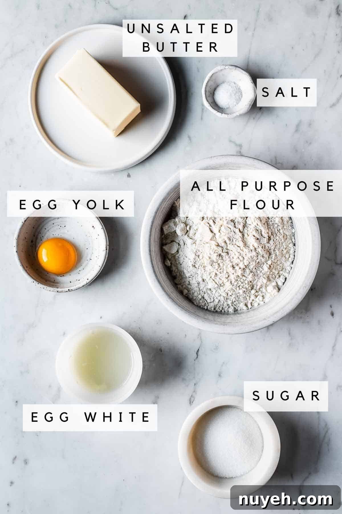 Labeled ingredients in bowls for pate sucree recipe.