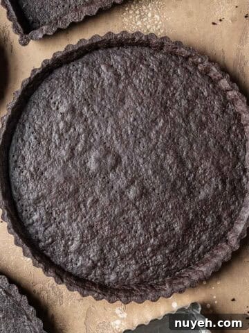 A round baked chocolate tart crust.