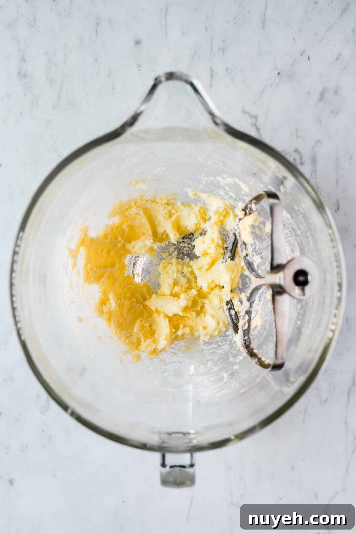 Mixing bowl with blended butter and sugar.