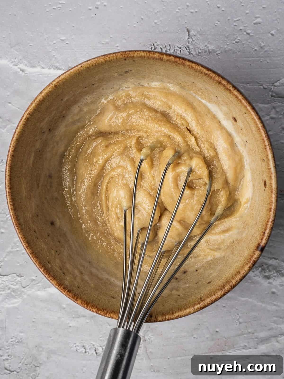 Tahini and lemon juice in a bowl.