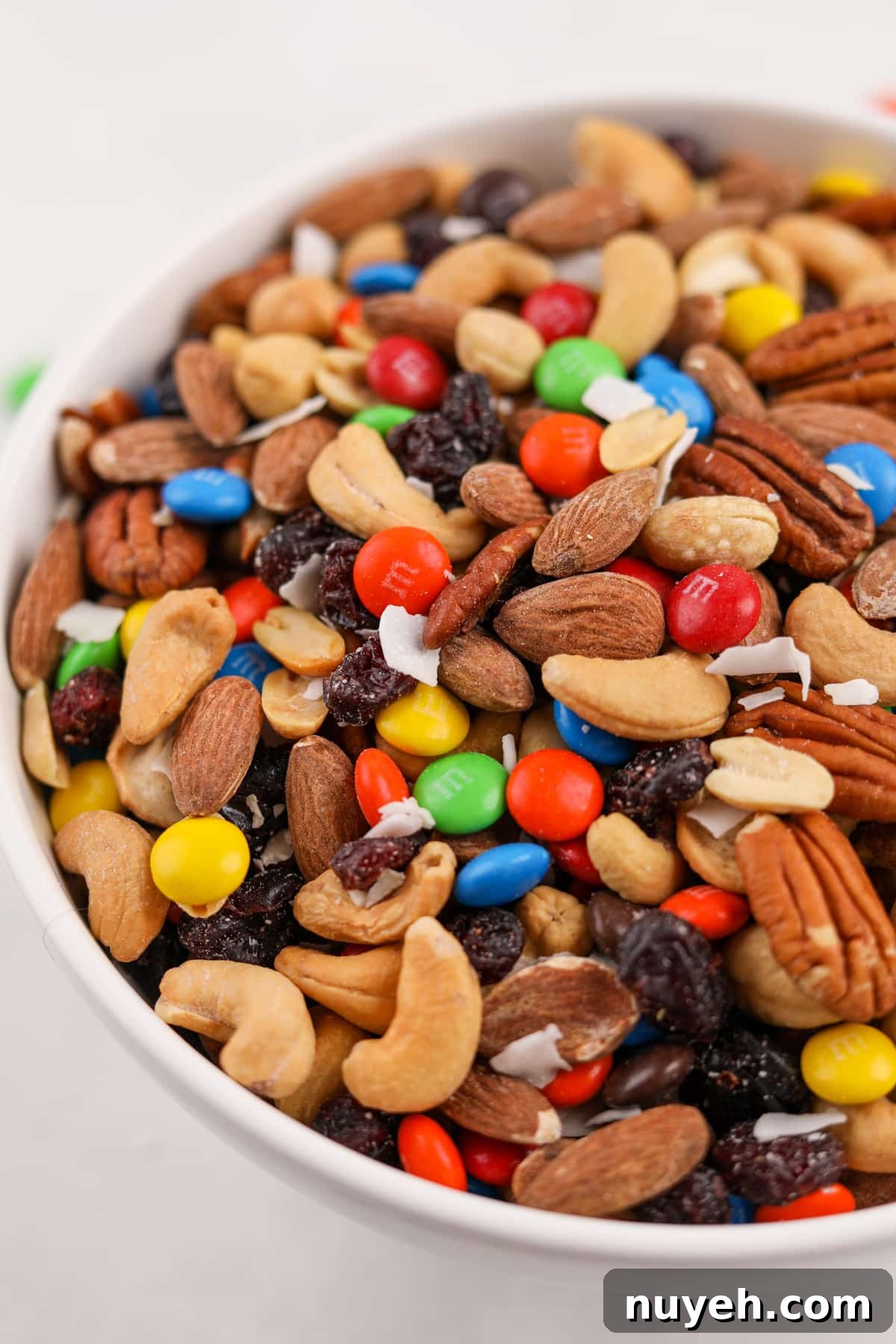 A bowl of trail mix dotted with m&m's.