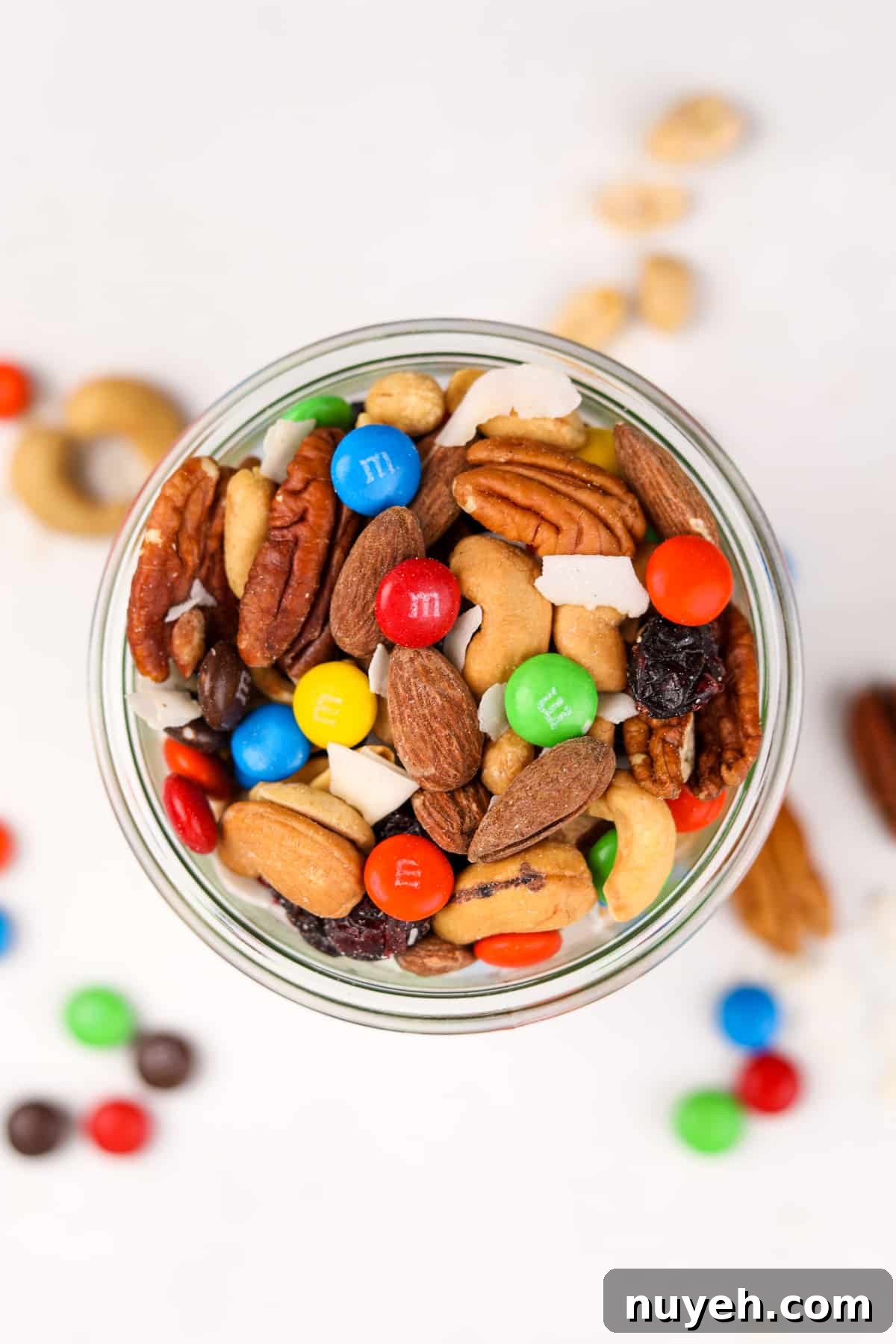 An overhead view of a mason jar filled with trail mix.