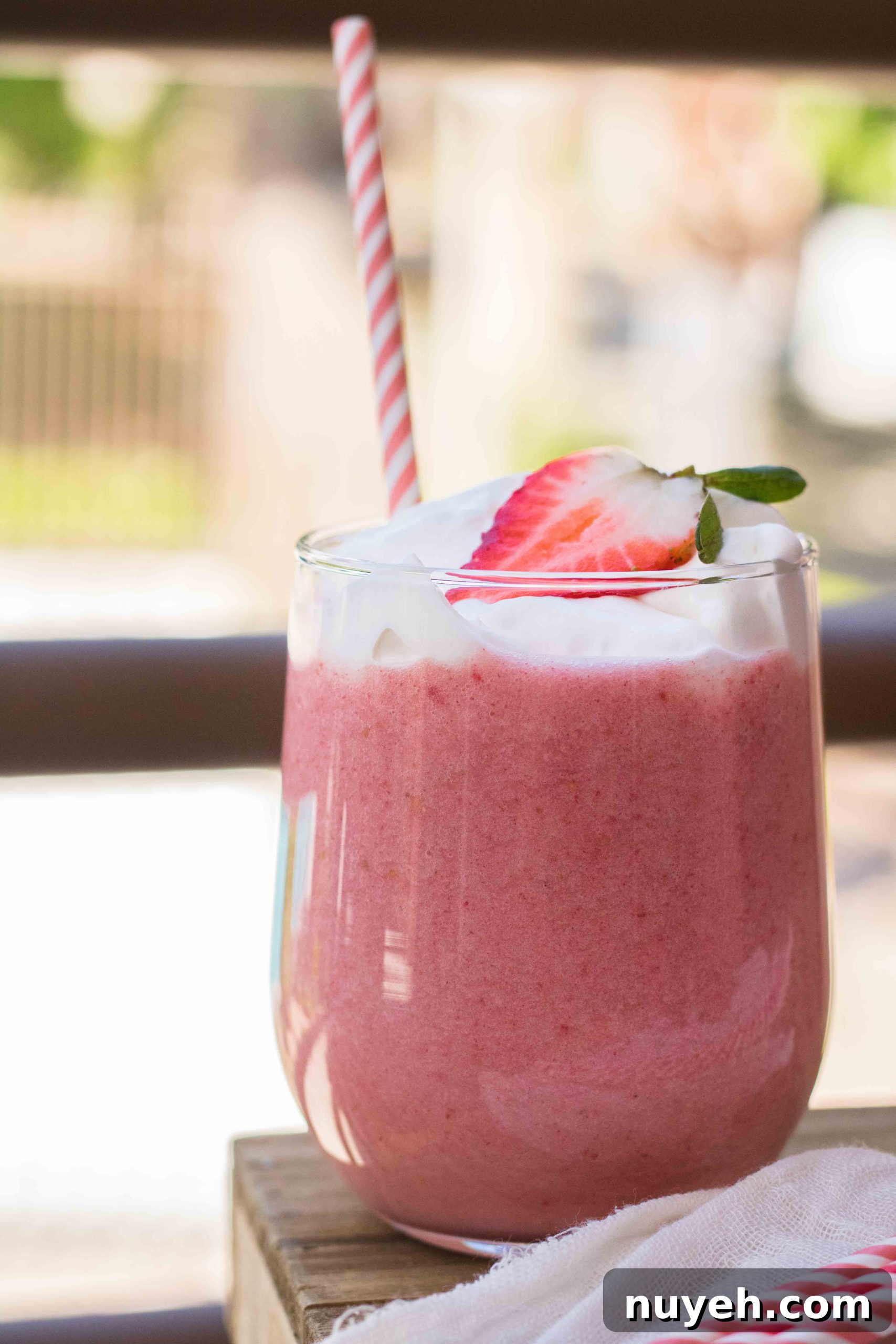 Creamy Strawberry Banana Yogurt Smoothie Recipe 4 Bright image of the best strawberry smoothie with yogurt topped with whipped cream.