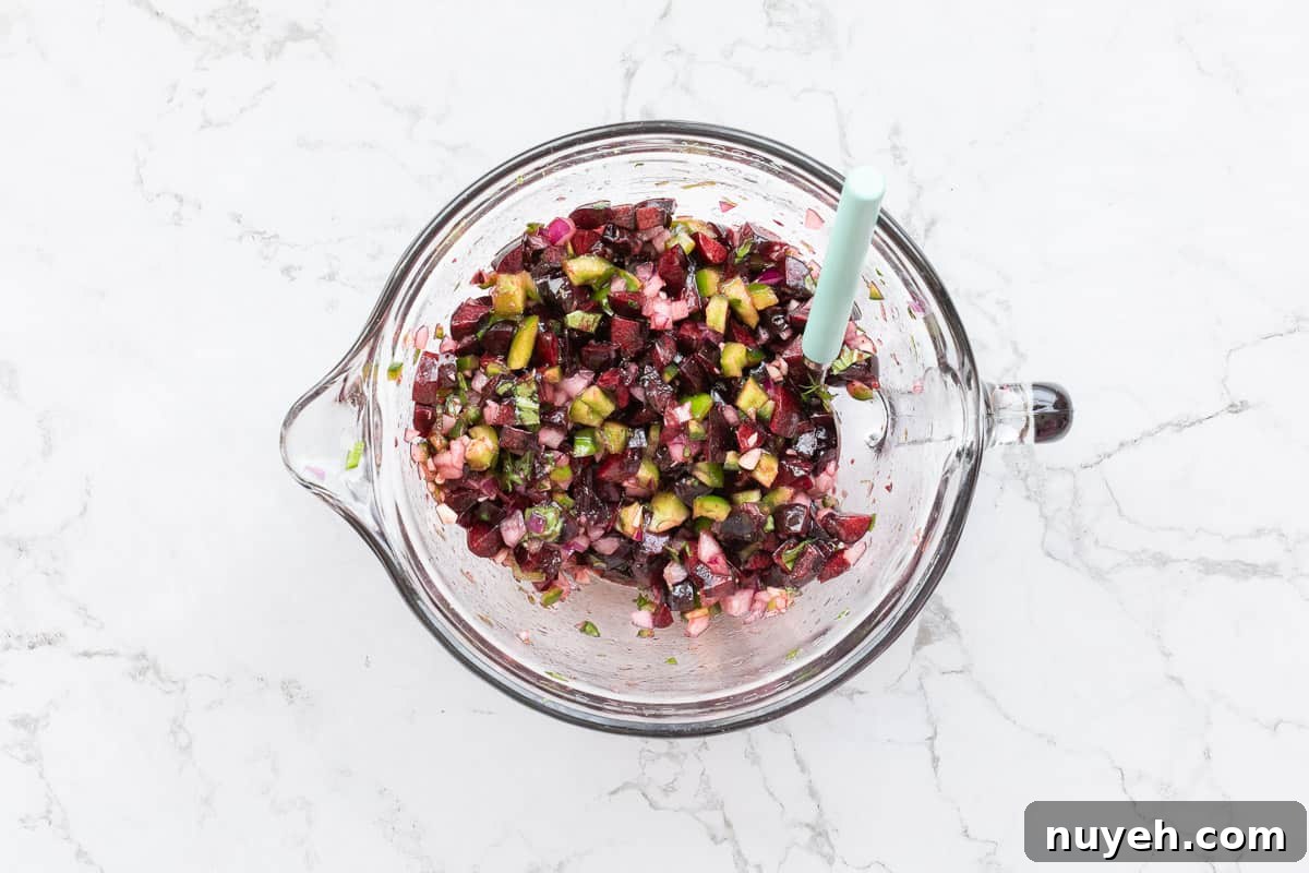cherry salsa with spoon in mixing bowl.