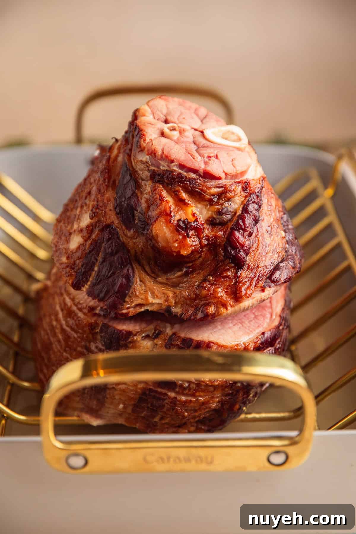 Roasted ham in pan with water.