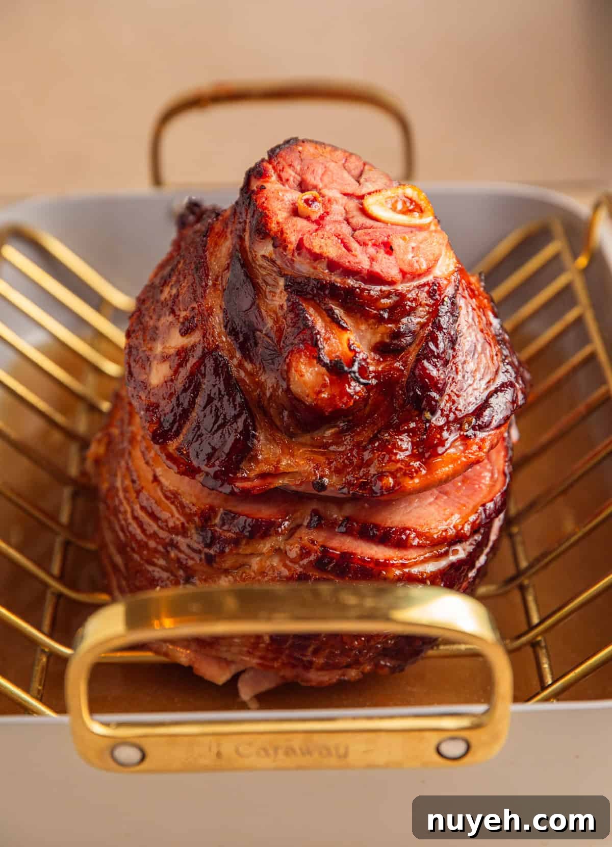 Apricot glazed ham after heating glaze in roasting pan.